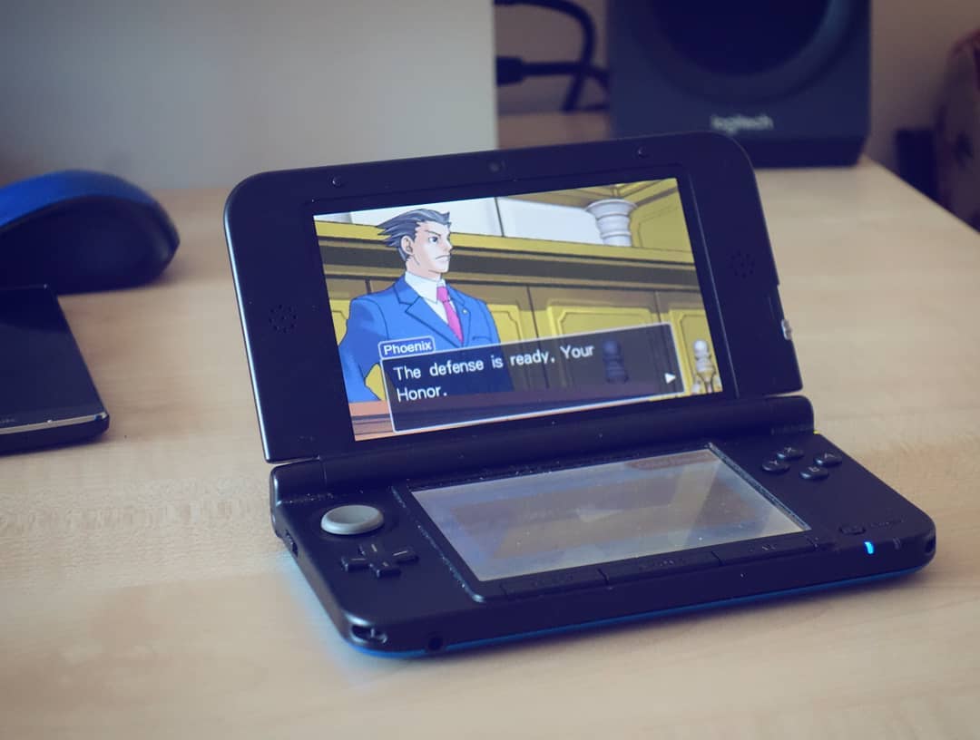 Photograph of a Nintendo 3DS playing Ace Attorney.